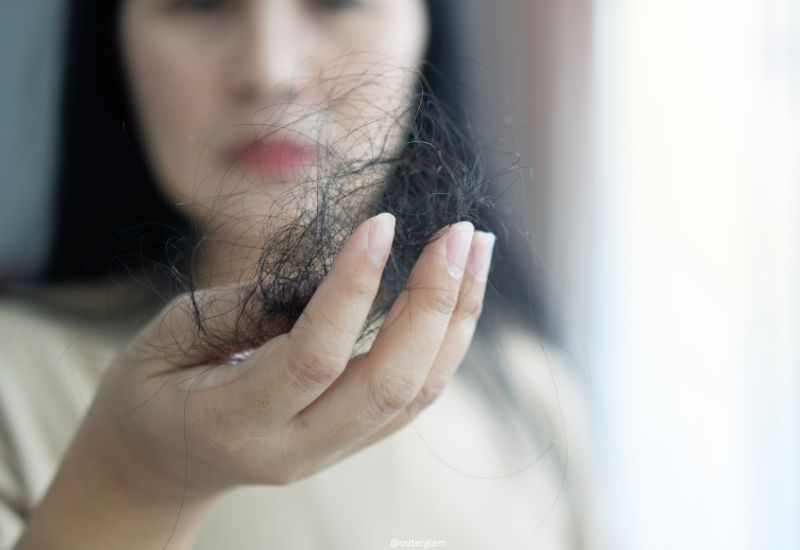 Attractive Asian woman serious about her hair and presentation hair loss problem