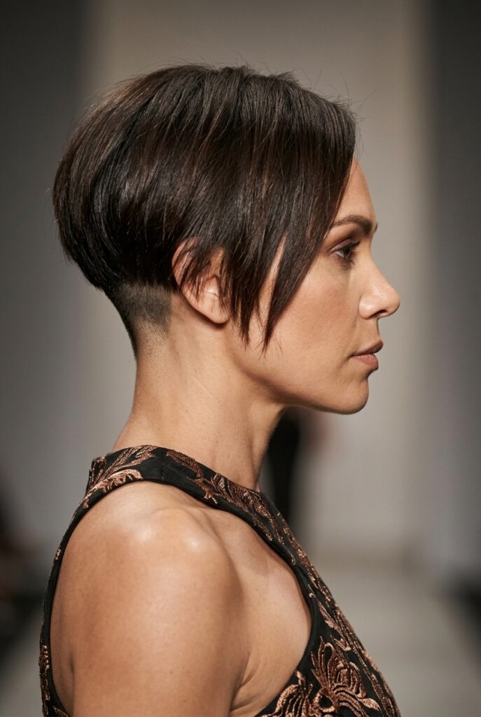 Australian Aboriginal fashion parade female model over 40 with an undercut pixie bob hairstyle