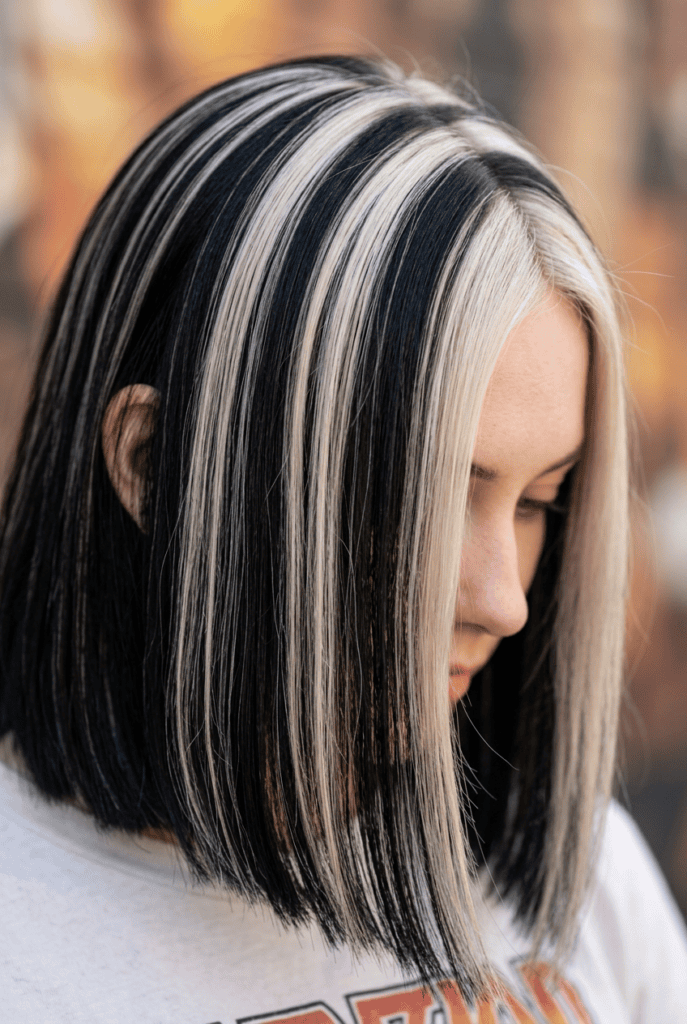 Chunky 90s-Inspired Highlights Bold chunky 90s highlights against dark hair