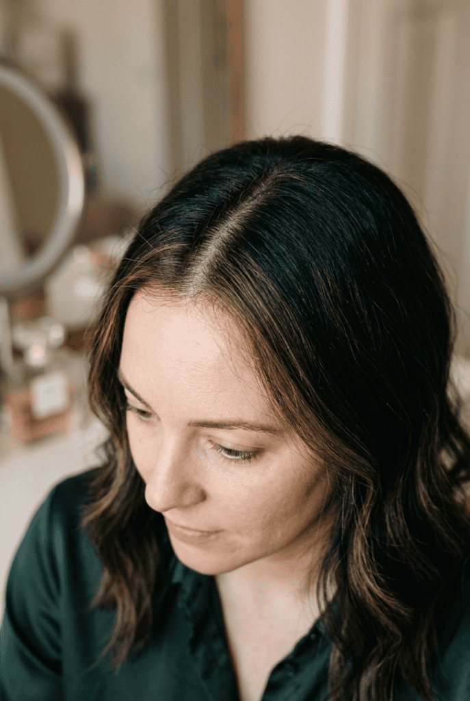 Woman with fine feathery balayage detailing along her hairline and part