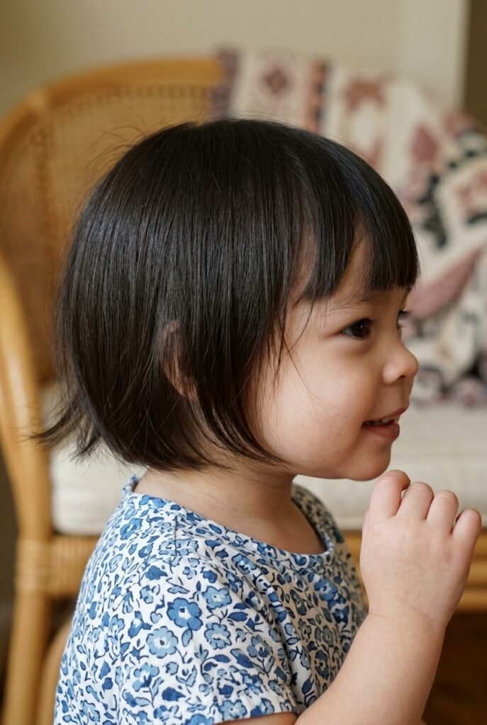 Filipino toddler girl, closeup to her simple trim with wispy ends haircut