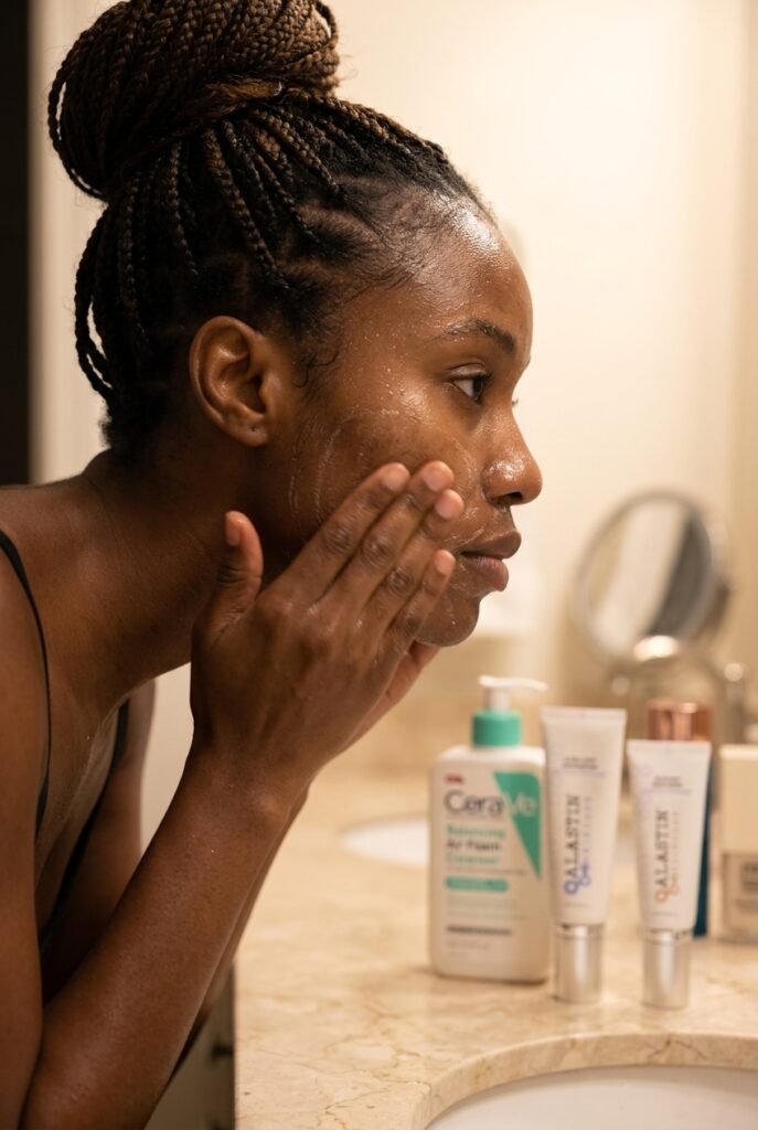 Nigerian woman in her 30s double cleansing her face at night