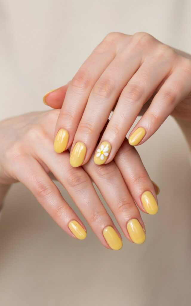 Teen girl hands with butter yellow daisy nail art