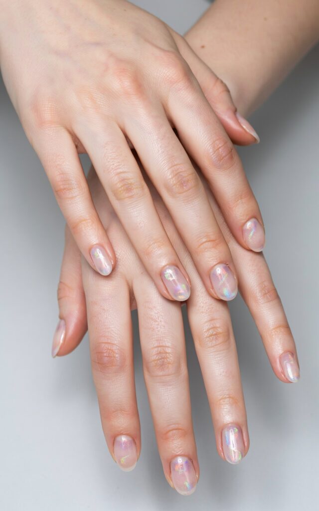 Teen girl hands with iridescent aurora nail art
