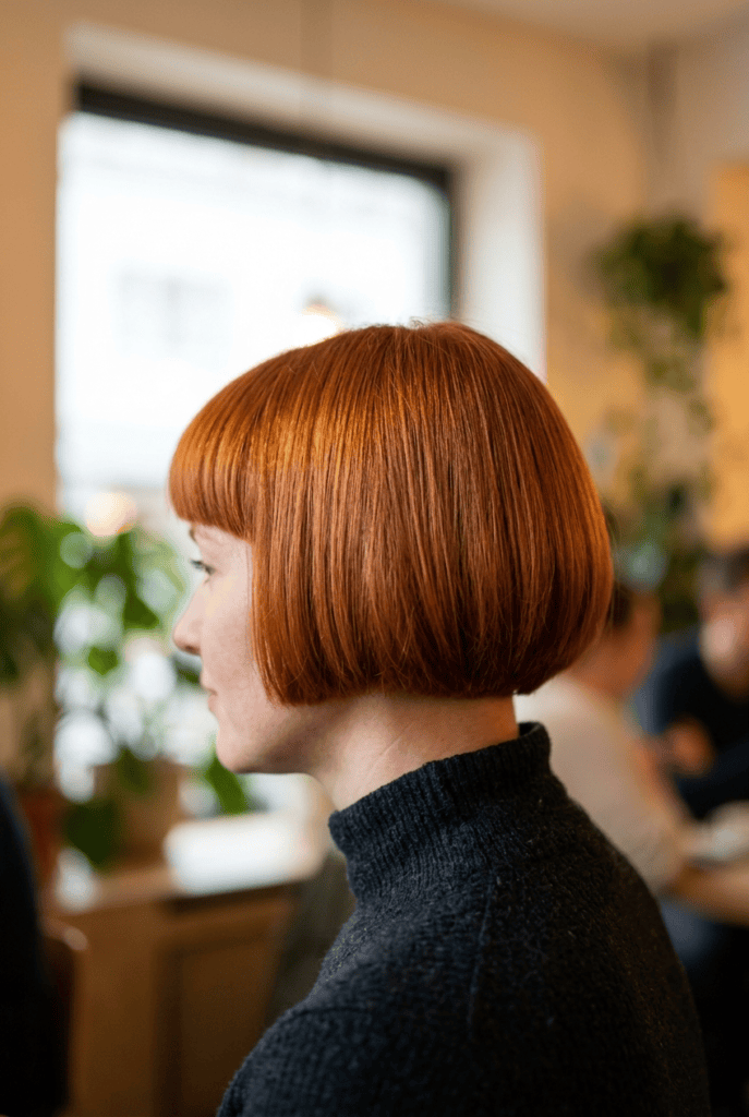 Woman with a cowboy bob haircut and full fringe