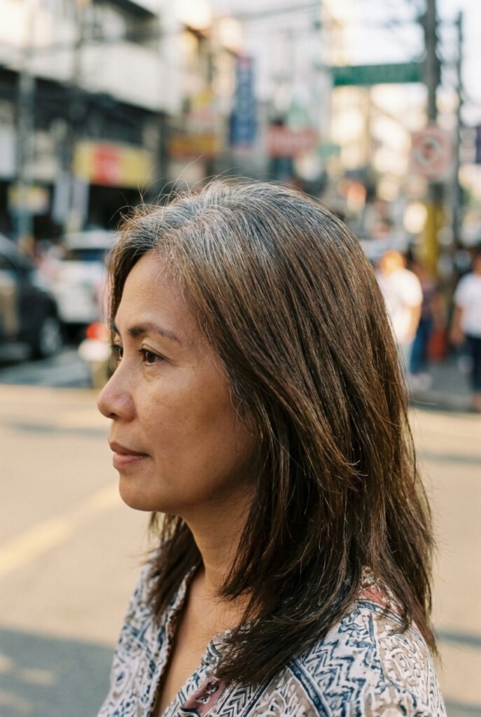 Woman with a softly smudged gray root standing on a city street