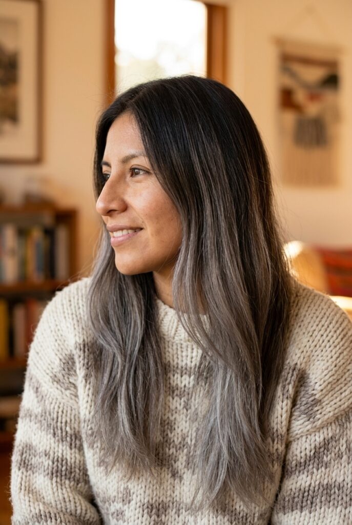 Woman with long gray balayage hair standing in a home interior